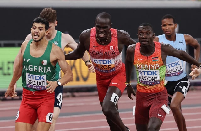 World Athletics Championships Tokyo 2025 - Men's 800m Final - Japan National Stadium, Tokyo, Japan - September 20, 2025 Kenya's Emmanuel Wanyonyi crosses the finish line to win gold ahead of silver medallist, Algeria's Djamel Sedjati and bronze medallist, Canada's Marco Arop REUTERS/Kim Kyung-Hoon