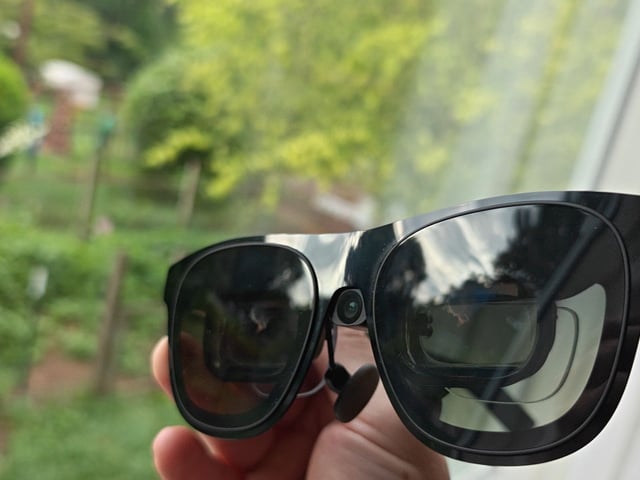 A pair of Xreal One smart glasses outfitted with an Xreal Eye camera and a set of HonsVR prescription lenses