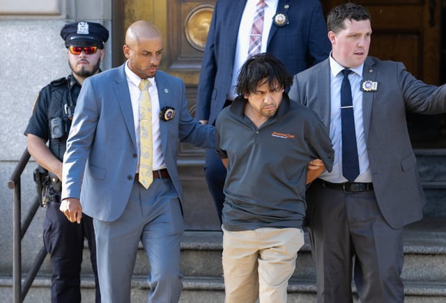 Franklin Batallas is pictured in police custody leaving the NYPD's 45th Precinct stationhouse on Friday, Sept. 19, 2025 in the Bronx. (Barry Williams/ New York Daily News)