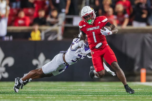 Isaac Brown #1 of the Louisville Cardinals runs the ball against DJ Barksdale #32 of the James Madison Dukes during the second half at L&N Federal Credit Union Stadium on September 5, 2025 in Louisville, Kentucky.