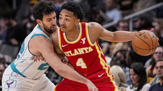 Apr 10, 2024; Atlanta, Georgia, USA; Atlanta Hawks guard Kobe Bufkin (4) is defended by Charlotte Hornets guard Vasilije Micic (22) during the second half at State Farm Arena. Mandatory Credit: Dale Zanine-Imagn Images