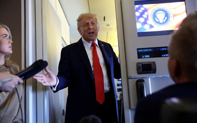 U.S. President Donald Trump speaks to reporters aboard Air Force One on his return from a state visit in Britain, September 18, 2025. REUTERS/Kevin Lamarque/File Photo