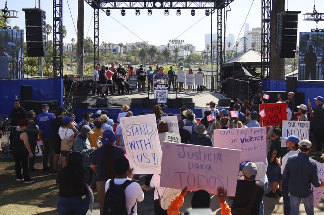 Supporters gather around a stage during an immigration rally on Saturday, Sept. 20, 2025, in Los Angeles. (AP Photo/Ethan Swope)