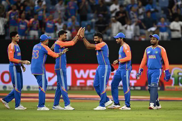 India's players celebrate after taking the wicket of Pakistan's Saim Ayub during the Asia Cup 2025 T20 cricket match between India and Pakistan at the Dubai International Stadium in Dubai on September 14, 2025.