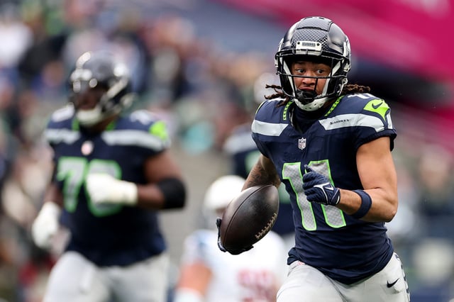 SEATTLE, WASHINGTON - NOVEMBER 24: Jaxon Smith-Njigba #11 of the Seattle Seahawks carries the ball against the Arizona Cardinals at Lumen Field on November 24, 2024 in Seattle, Washington.