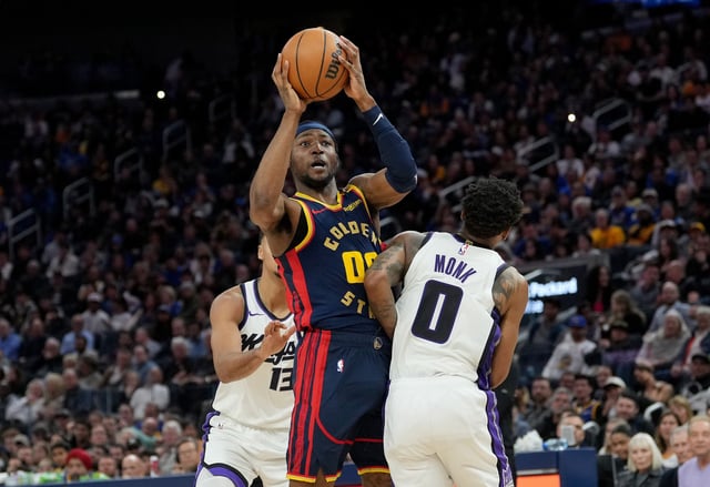 Jonathan Kuminga #00 of the Golden State Warriors goes up to shoot and gets fouled by Malik Monk #0 of the Sacramento Kings during the fourth quarter of an NBA basketball game at Chase Center on March 13, 2025 in San Francisco, California.