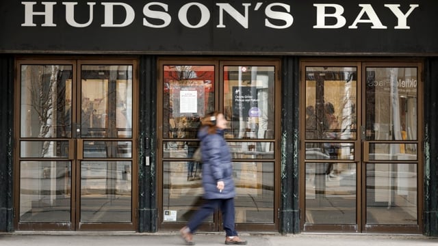 A pedestrian passes the Hudson's Bay store in downtown Calgary on March 20, 2025. After closing its stores earlier this year, the company's 1670 founding charter was moved to an undisclosed facility while it awaits its fate.