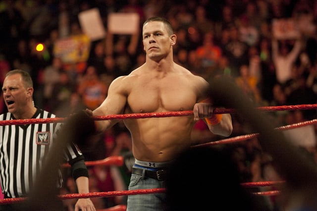 John Cena waits in the ring to face his opponents during WWE's Monday Night Raw at Rose Garden arena in Portland.