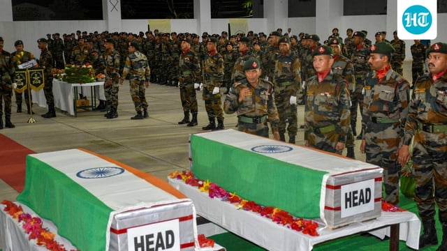 Security personnel pay tribute to the mortal remains of two jawans of the Assam Rifles who were killed when a group of armed men ambushed a vehicle of the paramilitary force