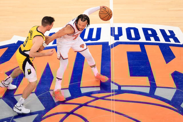 Knicks' point guard #11 Jalen Brunson (R) dribbles the ball under pressure from the Pacers' point guard #09 TJ McConnell (L) during Game Five of the Eastern Conference Finals of the 2025 NBA Playoffs between the New York Knicks and the Indiana Pacers at Madison Square Garden in New York on May 29, 2025.