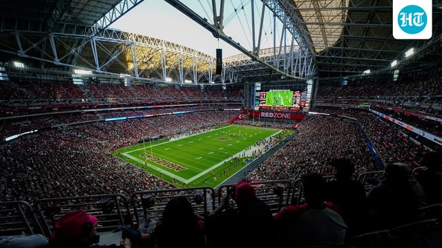 Spectators attend an NFL football game at State Farm Stadium in Glendale, Ariz.