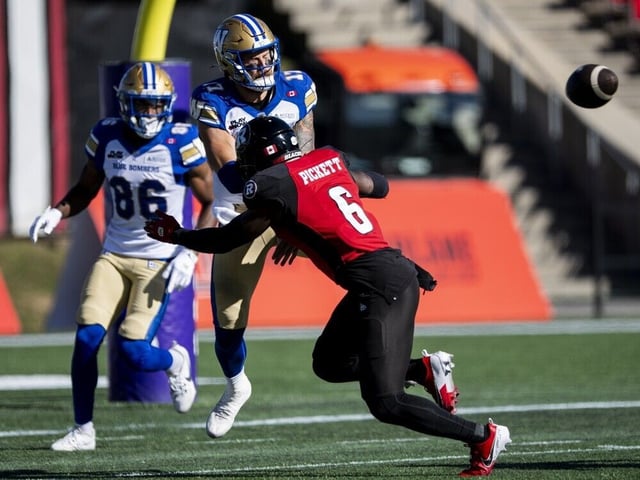  Redblacks linebacker Adarius Pickett (6) hits Blue Bombers quarterback Chris Streveler after he throws a pass in the first half of Saturday’s Canadian Football League game.
