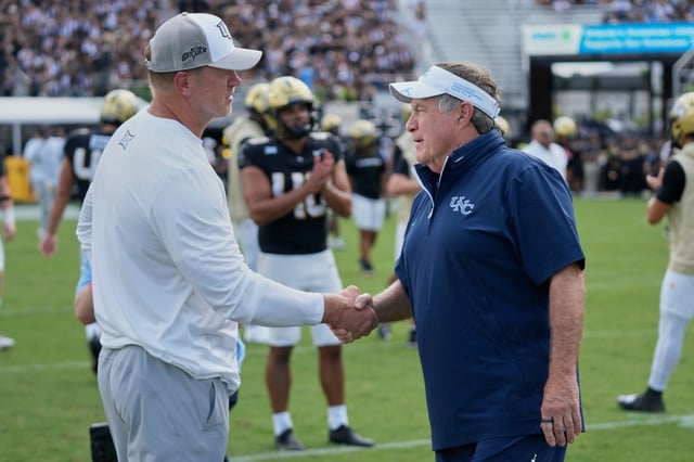 UCF head coach Scott Frost, left, and North Carolina head coach Bill Belichick shake hands before Saturday’s game.