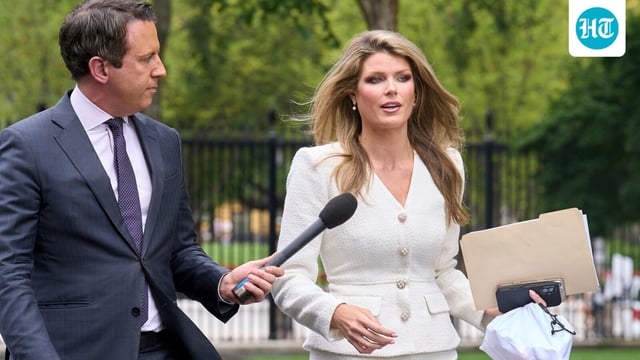 Lindsey Halligan, special assistant to the president, speaks with a reporter outside of the White House, Wednesday, Aug. 20, 2025, in Washington.