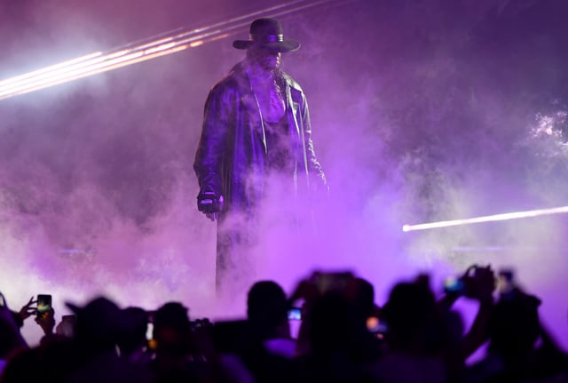 TOPSHOT - World Wrestling Entertainment star The Undertaker makes his way to the ring during a match at the World Wrestling Entertainment (WWE) Super Showdown event in the Saudi Red Sea port city of Jeddah late on January 7, 2019.