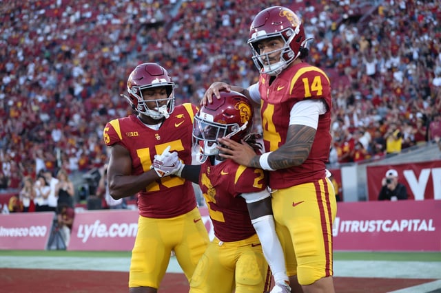 Jayden Maiava #14 and Jaden Richardson #15 congratulate Waymond Jordan #2 of the USC Trojans after his rushing touchdown during the second half of a game against the Georgia Southern Eagles at Los Angeles Memorial Coliseum on September 06, 2025 in Los Angeles, California.