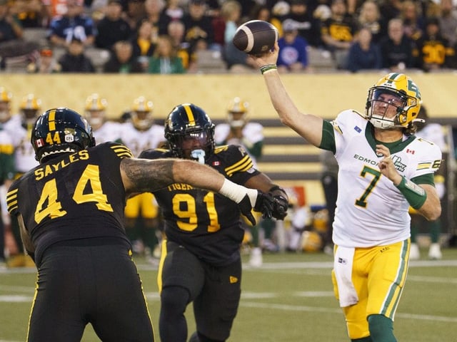 Edmonton Elks quarterback Cody Fajardo (7) throws while under pressure from Hamilton Tiger Cats defensive linemen Casey Sayles (44) and Miles Fox (91) during first quarter CFL football game action in Hamilton, Ont., Saturday, Sept. 20, 2025. 