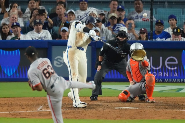 Dodgers’ Shohei Ohtani, second from left, heads hits a solo home run as San Francisco Giants relief pitcher Joel Peguero, left, and catcher Patrick Bailey watch during the sixth inning of a baseball game, Saturday, Sept. 20, 2025, in Los Angeles. (AP Photo/Mark J. Terrill)
