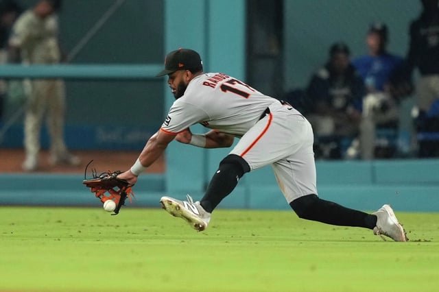 San Francisco Giants left fielder Heliot Ramos fields a ball hit for a single by the Los Angeles Dodgers’ Michael Conforto during the fifth inning Saturday in Los Angeles.