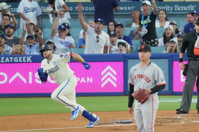 The Dodgers’ Max Muncy heads to first base as he watches the flight of the baseball, which became a two-run home run, as Giants starting pitcher Kai-Wei Teng watches during the first inning Saturday in Los Angeles. 