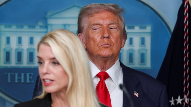 FILE PHOTO: U.S. President Donald Trump looks on as U.S. Attorney General Pam Bondi speaks during a press conference about deploying federal law enforcement agents in Washington to bolster the local police presence, in the Press Briefing Room at the White House, in Washington D.C., U.S., August 11, 2025. REUTERS/Jonathan Ernst/File Photo