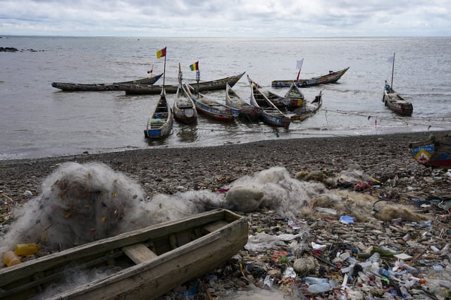Fishing boats are anchored along the shore in Conakry, Guinea, Friday, Sept. 19, 2025 (AP Photo/Misper Apawu)