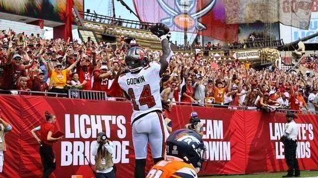 Sep 22, 2024; Tampa, Florida, USA; Tampa Bay Buccaneers wide receiver Chris Godwin (14) celebrates after he scored a touchdown against the Denver Broncos during the first half at Raymond James Stadium. Mandatory Credit: Kim Klement Neitzel-Imagn Images