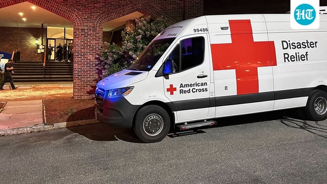 An American Red Cross Disaster Relief van is parked outside a hotel that is acting as a reunification center after a shooting at a country club in Nashua, New Hampshire, Saturday, Sept. 20, 2025. (AP Photo/Michael Casey)