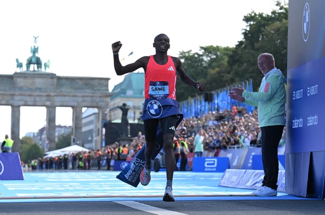Athletics - Berlin Marathon - Berlin, Germany - September 21, 2025 Kenya's Sabastian Sawe crosses the line to win the Men's elite race REUTERS/Annegret Hilse
