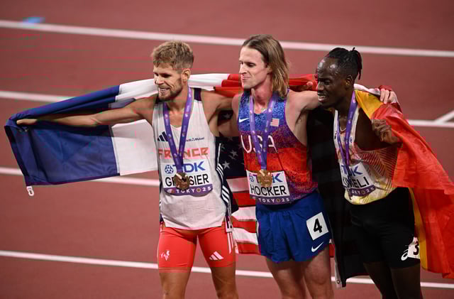 World Athletics Championships Tokyo 2025 - Men's 5000m Final - Japan National Stadium, Tokyo, Japan - September 21, 2025 Cole Hocker of the U.S. celebrates winning the gold medal with silver medallist Belgium's Isaac Kimeli and bronze medallist France's Jimmy Gressier REUTERS/Dylan Martinez