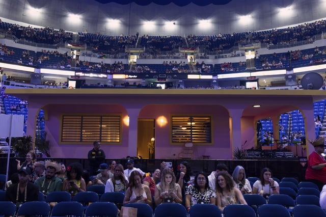 Fans sit in front of "La Casita" before Bad Bunny final concert of his summer residency in his homeland at the Coliseo de Puerto Rico Jose Miguel Agrelot, in San Juan, Puerto Rico, Saturday, Sept. 20, 2025. (AP Photo/Alejandro Granadillo)