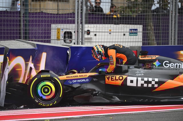 Oscar Piastri climbs out of his damaged car after crashing during the first lap.