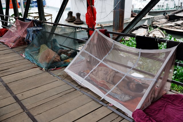 People sleep using mosquito nets, following a surge of dengue-infected patients, in Dhaka, Bangladesh, June 25, 2025. REUTERS/Mohammad Ponir Hossain/File Photo