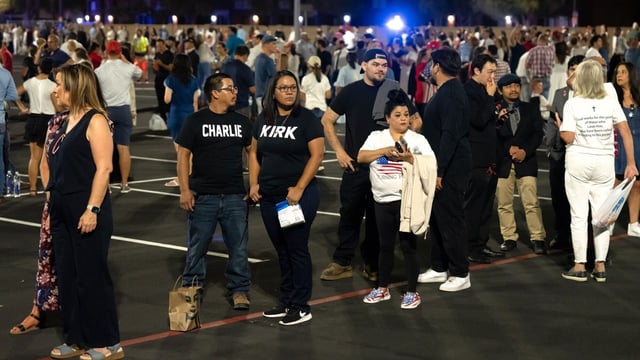 Attendees wait in line to enter a memorial service for Turning Point USA founder Charlie Kirk at State Farm Stadium in Glendale, Arizona, US, on Sunday, Sept. 21, 2025. President Donald Trump is set to eulogize Charlie Kirk as a patriot and Christian martyr on Sunday as the political activist's assassination continues to galvanize conservative support for the president. Photographer: Rebecca Noble/Bloomberg