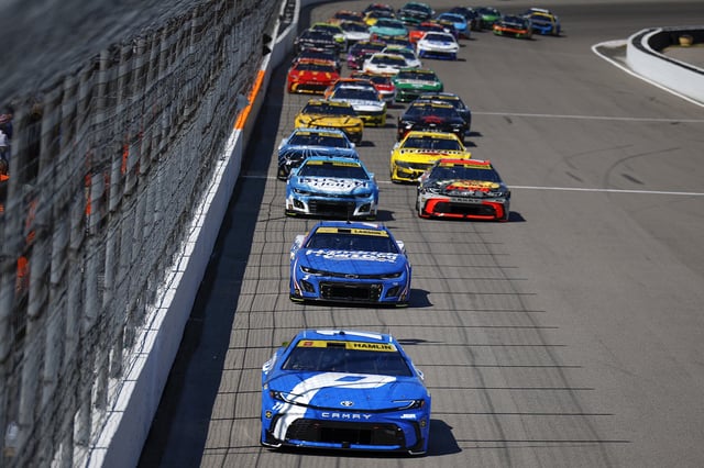 Denny Hamlin, driver of the #11 Progressive Toyota, and Kyle Larson, driver of the #5 HendrickCars.com Chevrolet, race during the NASCAR Cup Series Enjoy Illinois 300 at WWT Raceway on September 07, 2025 in Madison, Illinois.
