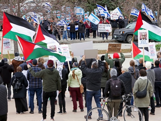 Counter-rallies with flags representing Israel and Palestine at the Canadian Museum for Human Rights in Winnipeg on Sunday, Oct. 22, 2023. 