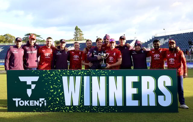 Cricket - Third Twenty20 International - Ireland v England - The Village, Malahide, Ireland - September 21, 2025 England team members celebrate winning the series with a trophy REUTERS/Cathal Mcnaughton