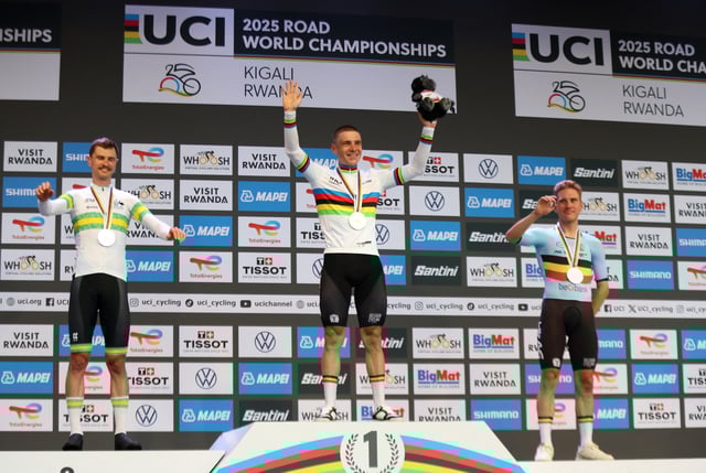 Cycling - Road World Championships 2025 - Kigali, Rwanda - September 21, 2025 Gold medallist, Belgium's Remco Evenepoel celebrates on the podium after winning the Men's Elite Individual Time Trial alongside silver medallist, Austria's Jay Vine and bronze medallist, Belgium's Ilan Van Wilde REUTERS/Jean Bizimana
