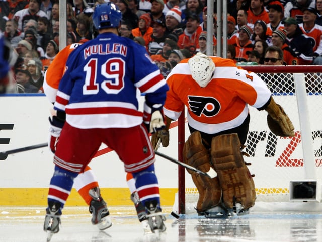 Philadelphia Flyers goalie Bernie Parent (R) makes a kick save against the New York Rangers during the first period of the 2012 NHL Winter Classic Alumni ice hockey game at the Ballpark in Philadelphia, Pennsylvania, December 31, 2011. REUTERS/Tim Shaffer
