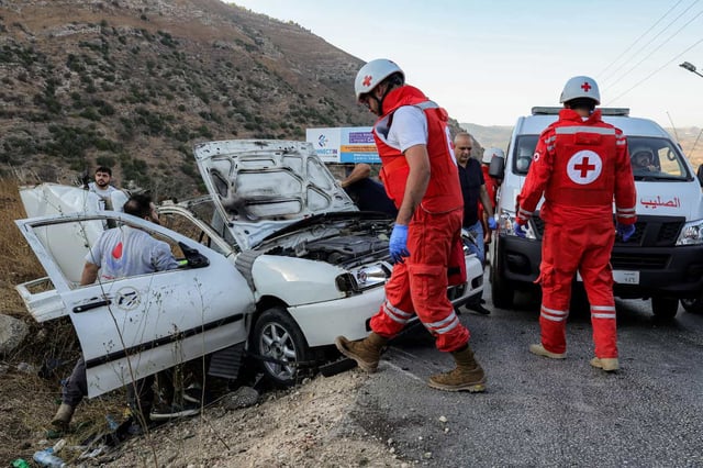 First responders and security forces' members gather at the site of an Israeli strike on a vehicle on the Khardali road in south Lebanon's Marjayoun area on September 20, 2025. Lebanon's Health Ministry said one person was killed in the strike, the latest deadly raid despite a months-old ceasefire between Israel and the Hezbollah militant group. (Photo by Rabih DAHER / AFP)