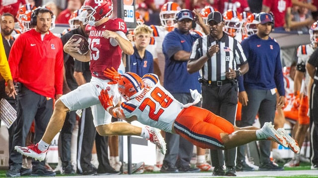 Indiana's Fernando Mendoza (15) is pushed by Illinois' Dylan Rosiek (28) as he runs during the Indiana versus Illinois football game at Memorial Stadium on Saturday, Sept. 20, 2025
