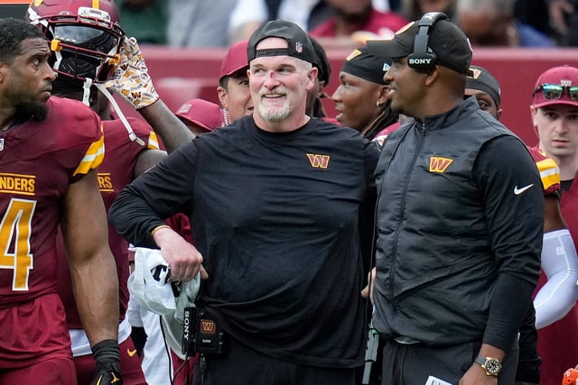 Washington Commanders head coach Dan Quinn, center, after he hurt his nose during a game against the Las Vegas Raiders on Sept. 21, 2025.