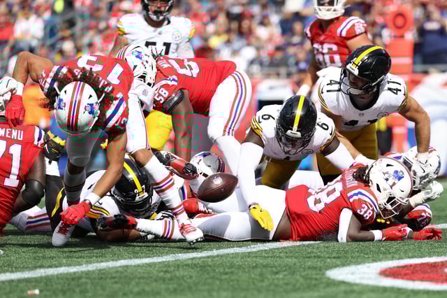 FOXBOROUGH, MASSACHUSETTS - SEPTEMBER 21: Patrick Queen #6 of the Pittsburgh Steelers forces a fumble from Rhamondre Stevenson #38 of the New England Patriots during the third quarter at Gillette Stadium on September 21, 2025 in Foxborough, Massachusetts.