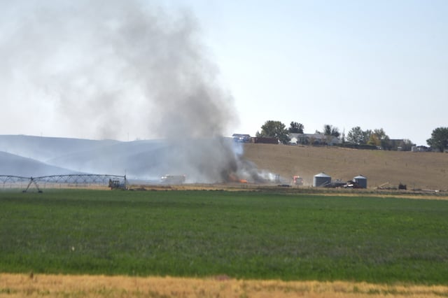 NEWS PHOTO JAMES TUBB Fire crews from Cypress County, Medicine Hat and Suffield battle flames from a wildfire Sunday east of Dunmore along Range Road 40.