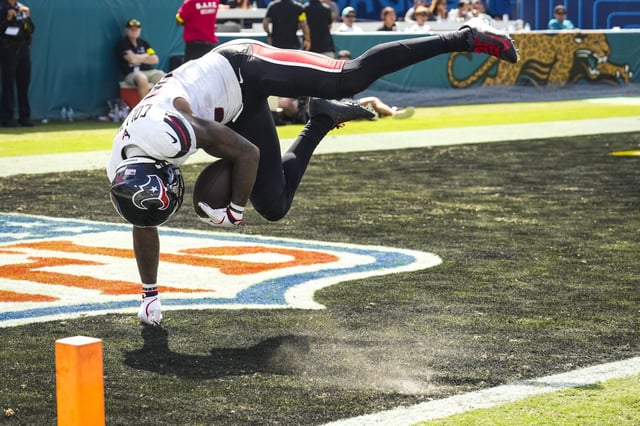 Houston Texans wide receiver Nico Collins (12) dives into the end zone on a 50-yard touchdown reception against the Jacksonville Jaguars during the second half of an NFL football game at Everbank Stadium in Jacksonvillew, Fla., Sunday, Sept. 21, 2025.