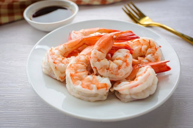 STOCK IMAGE: Boiled shrimp in white ceramic plate on white background