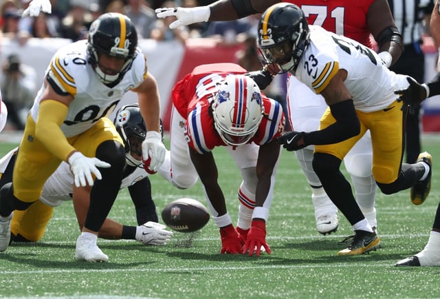 Foxboro, MA - New England Patriots running back Rhamondre Stevenson fumbles the ball during the first quarter of the game at Gillette Stadium. (Nancy Lane/Boston Herald)