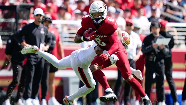Sep 21, 2025; Santa Clara, California, USA; Arizona Cardinals running back James Conner (6) avoids the tackle by. San Francisco 49ers cornerback Deommodore Lenoir (2) during the first half at Levi's Stadium. Mandatory Credit: Kyle Terada-Imagn Images