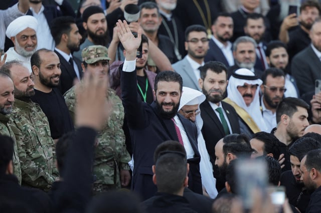 Syria’s interim President Ahmed al-Sharaa waves as he attends the “Aleppo, Key to Victory” celebration marking Syria’s liberation, in Aleppo, Syria May 27, 2025. REUTERS/Khalil Ashawi/File Photo