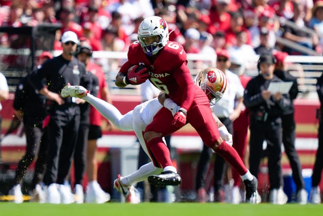 Sep 21, 2025; Santa Clara, California, USA; Arizona Cardinals running back James Conner (6) avoids the tackle by. San Francisco 49ers cornerback Deommodore Lenoir (2) during the first half at Levi's Stadium. Mandatory Credit: Kyle Terada-Imagn Images/File Photo